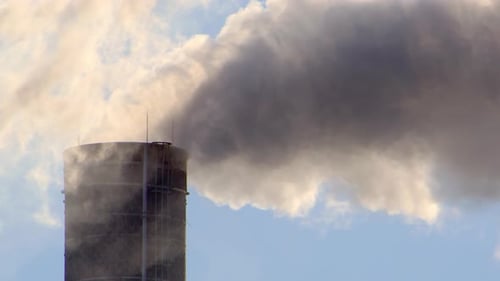 Choking plumes of factory smoke carbon emissions released into atmosphere, zoom