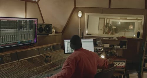 Producer and Singer Recording in Music Studio