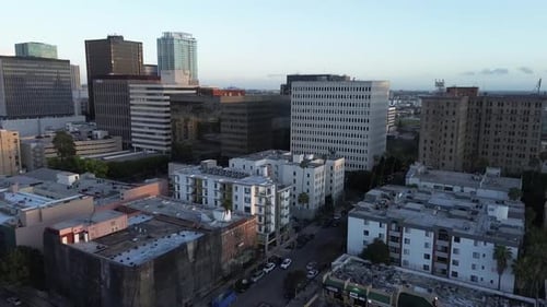 Dynamic drone pan of urban city in Los Angeles during golden hour.
