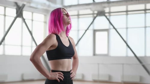 Woman with Pink Hair Taking a Break at Gym