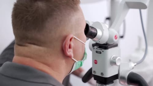 Healthcare Worker Uses Microscope for Research