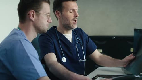Doctors Reviewing X-Ray Results in Hospital