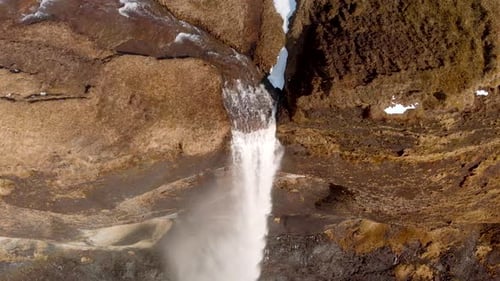 Drone shot of a waterfall in Iceland. Shot above the waterfall