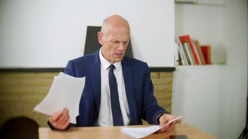 Stressed Man Throwing Papers in the Office