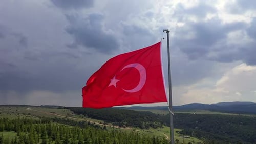 Waving Turkish Flag in Rural Landscape