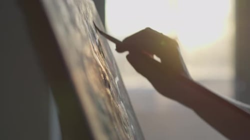 Artist's Hands Painting Abstract Art in Sunlight