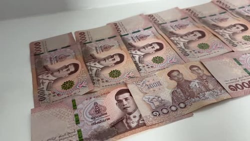 Close up shot of Thai baht Thailand cash currency THB bills and bank notes money economy