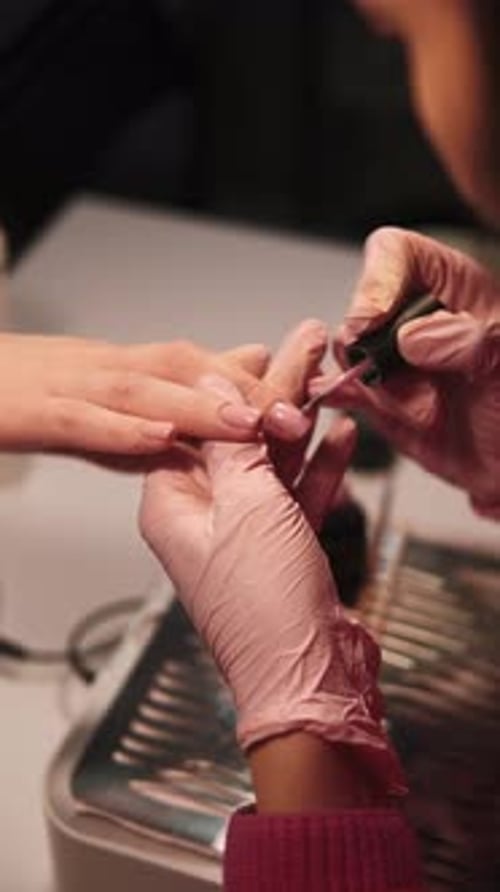 Woman Receiving Manicure at Nail Salon, Close-Up