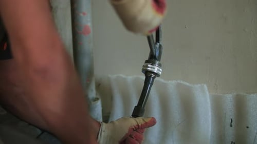 Man Connecting Water Pipes With Wrench