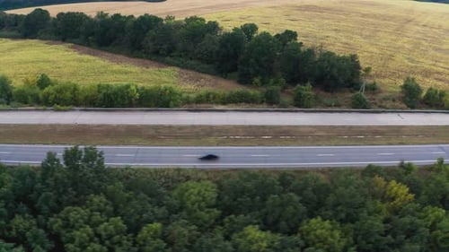 Long Twolane Concrete Road with Traffic in Rural Area