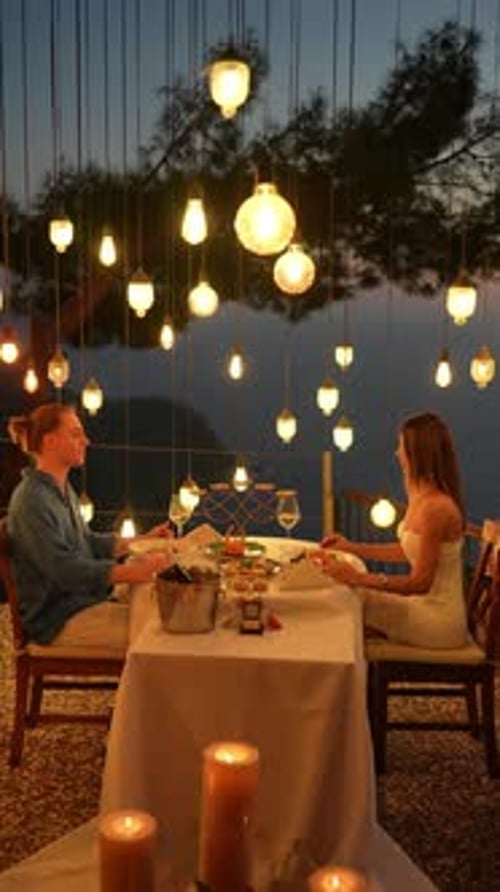 Romantic couple having dinner at sunset