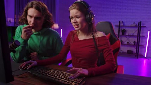 Excited Young Adults Playing Video Games Together