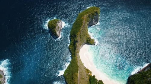 Mountain Range Sticks Out Near Pristine White Sandy Beach and Blue Ocean Waves Clear Sea of