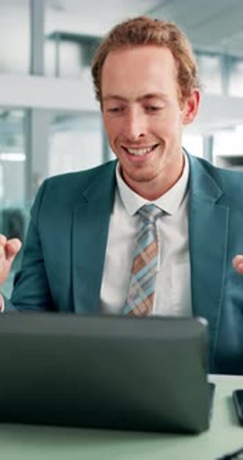 Man, laptop and success with fist pump in office, goals or revenue growth with dividend results