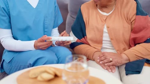 Health Worker Discussing Medication with Senior Adult