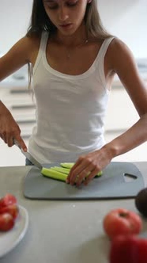 Young Woman Preparing a Healthy Meal in Kitchen