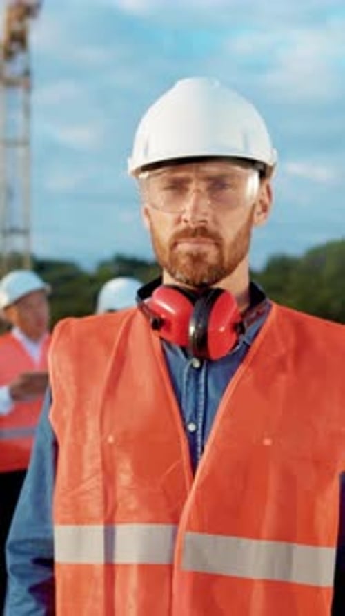 A Construction Worker in Safety Gear on a Building Site Focused on Their Task at Hand