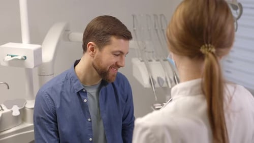 Young woman dentist holding x ray image