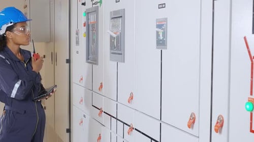 Woman Engineer Inspecting Electrical Panels