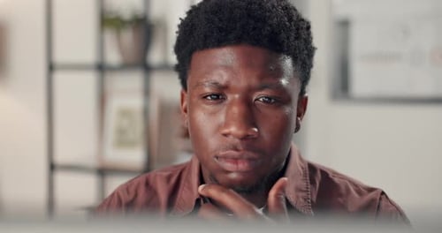 Creative, black man and reading with laptop in office of research, editor feedback and proofreading