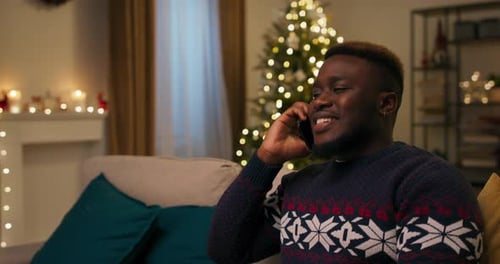 Man Talking on Phone During Christmas at Home