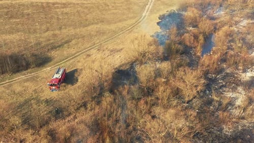 Aerial View Spring Dry Grass Burns During Drought Hot Weather Bush Fire And Smoke Fire Engine Fire