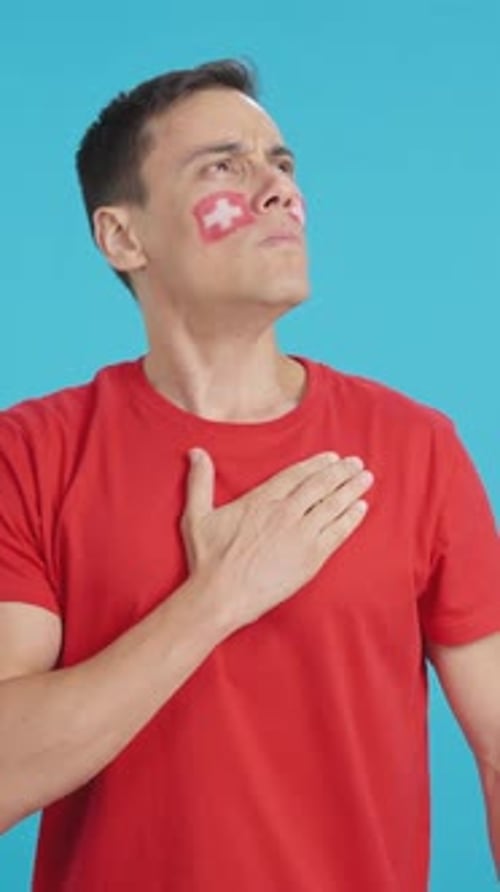 Man Listening to the Switzerland National Anthem with Solemnity