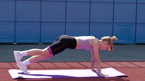 Athletic Woman Performing Leg Lift Exercise With Band