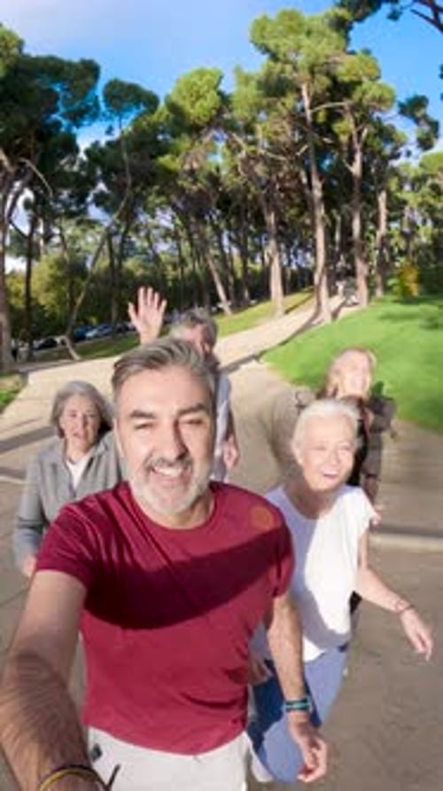 Active Senior Friends Running Together in Park Selfie Video