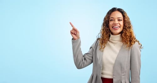 Happy business woman, pointing and advertising in marketing on mockup against a blue studio