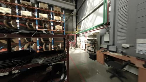 Camera Travels Through Industrial Aisles in Busy Warehouse