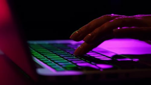 Close Up of Fingers Typing on a Colorful Laptop Keyboard