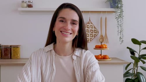 Confident Portrait of Mid Adult Businesswoman Looking at Camera From the Kitchen