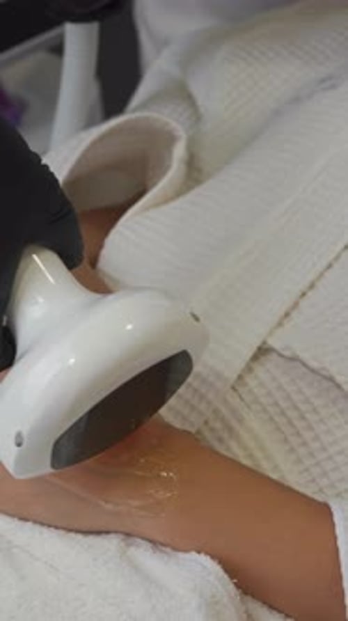 Cosmetic Treatment Device Used on Woman's Arm