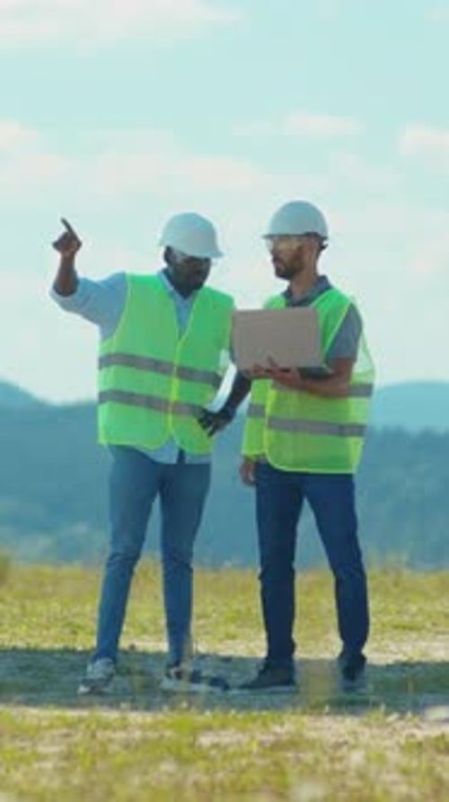 Dedicated Construction Workers are Collaborating Effectively on Detailed Site Plans and Strategies