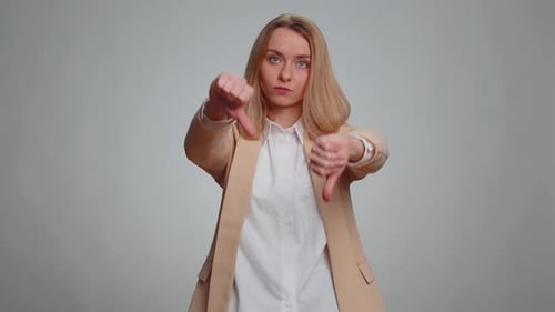 Woman Thumbs Down in Neutral Setting