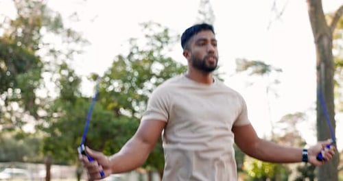 Outdoor, cardio and man skipping with a rope in park, forest or healthy fitness training in nature