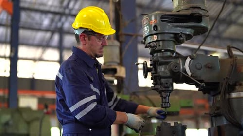 Industrial factory employee working in metal manufacturing industry