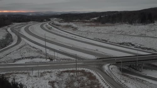 Empty Highway Covered With Snow In Winter - Cold Sunrise Scenery - aerial drone