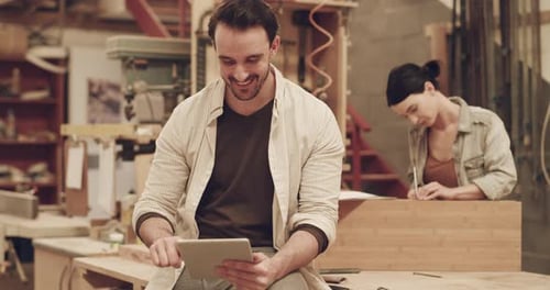 4k video footage of two young carpenters working in their woodworking workshop