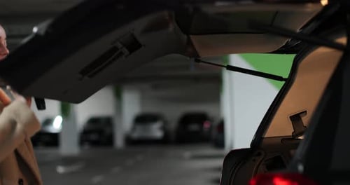 Young Woman Puts Paper Bags Opened Car Trunk Shopping Sale Discounts in Stores