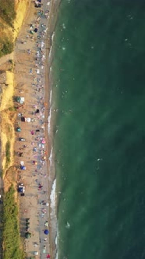 Aerial View of Sandy Beach Swimming People in Sea Bay with Transparent Blue Water at Sunset in