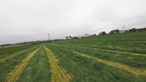 Plowed farm field in American Rural Area during cloudy day. Speed low angle fpv flight. Rural agricu