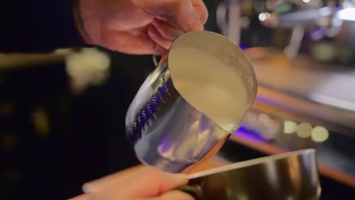Create a professional milk froth heart on a cup of coffee