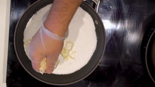 Slow motion view of adding tapioca flour to cook sandwich