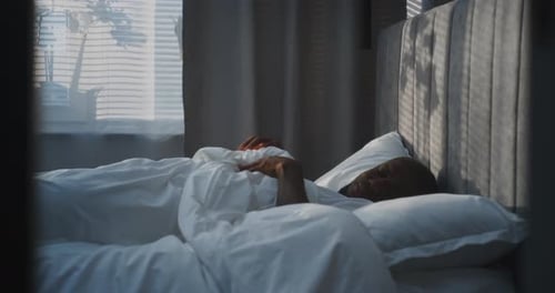 Man waking up and checks his smartphone