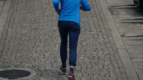 Young Man Jogging Up on Hill in City, Super 240