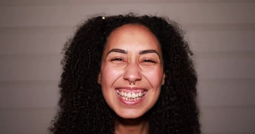 Close Up Portrait of a Smiling Young Woman with Curly Hair