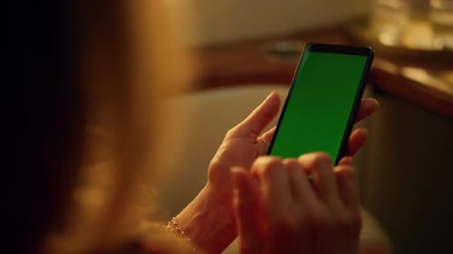 Woman Scrolling Green Screen Phone on Plane