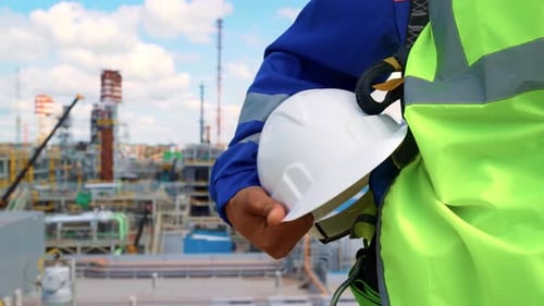 Man Industrial Worker Metalworker Builder Safety Uniform Protective Helmet at Refinery Construction